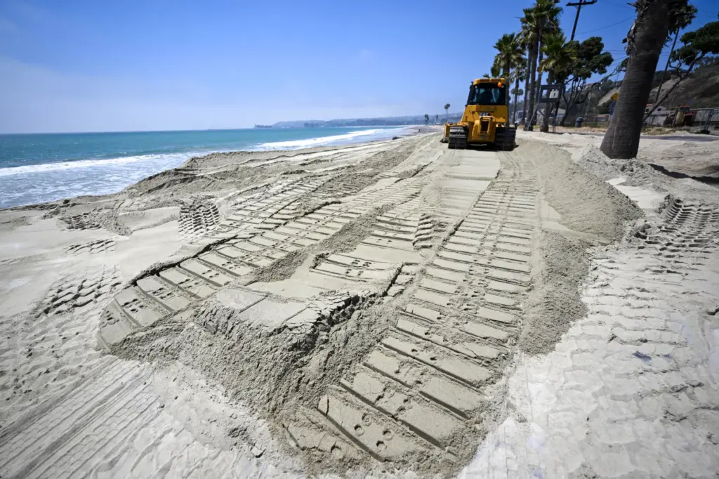 The first of 13,500 cubic yards of sand is delivered...