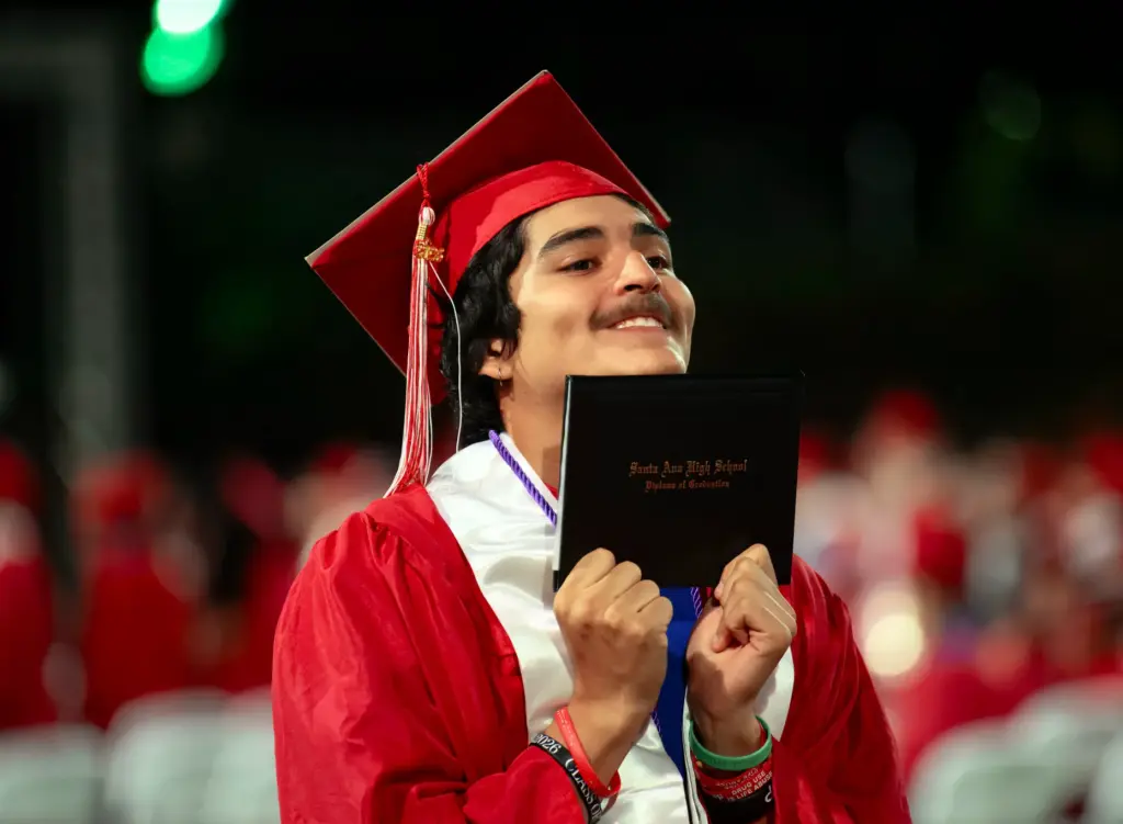 Chris Contreras holds his diploma close during the Santa Ana...