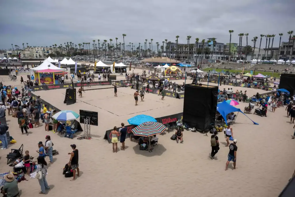 Fans line the sand around volleyball courts north of the...