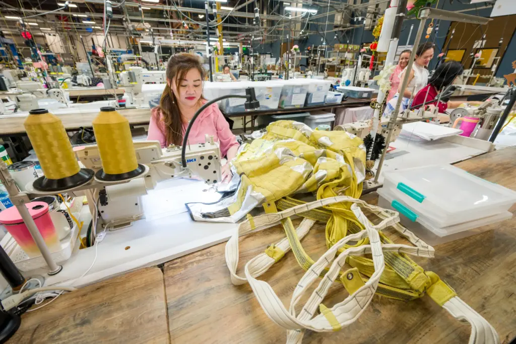 Lan Ngo sews a parachute deployment bag at Airborne Systems...