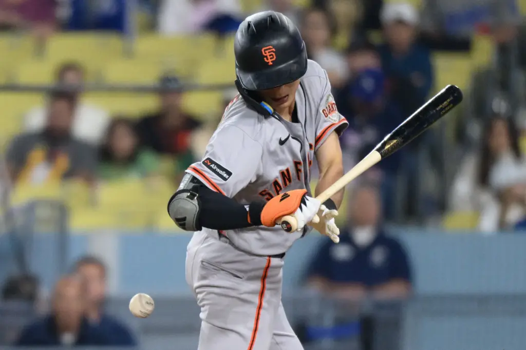 The San Francisco Giants’ Jung Hoo Lee gets hit by...