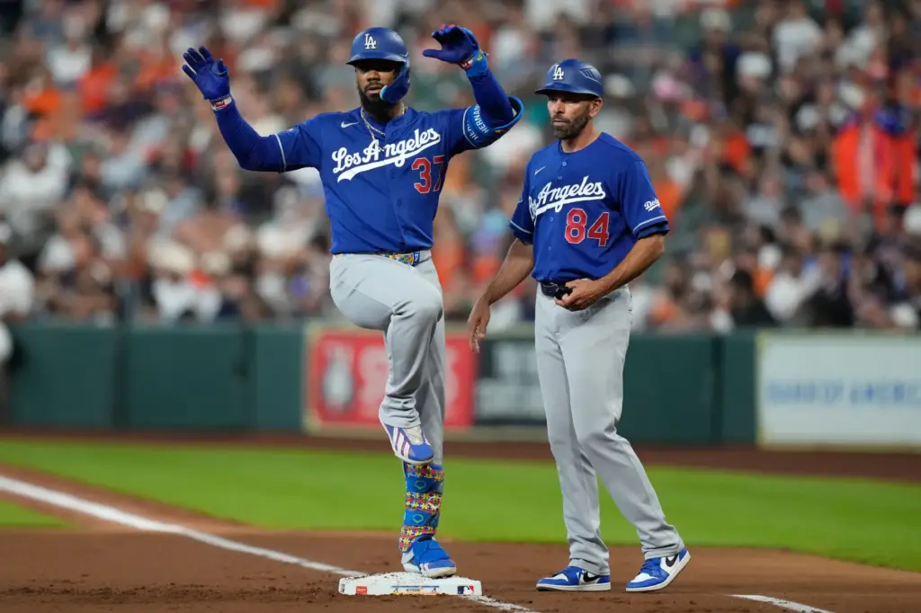 The Dodgers’ Teoscar HernÃ¡ndez, left, gestures to his dugout after...