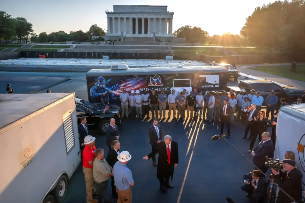 President Donald Trump talks as he visits the Lincoln Memorial Reflecting Pool.