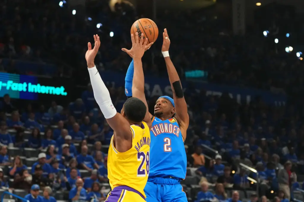 Oklahoma City Thunder guard Shai Gilgeous-Alexander, right, shoots as Lakers...