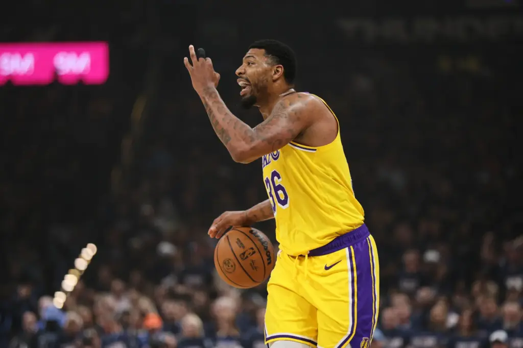 Los Angeles Lakers’ Marcus Smart signals to teammates in the...