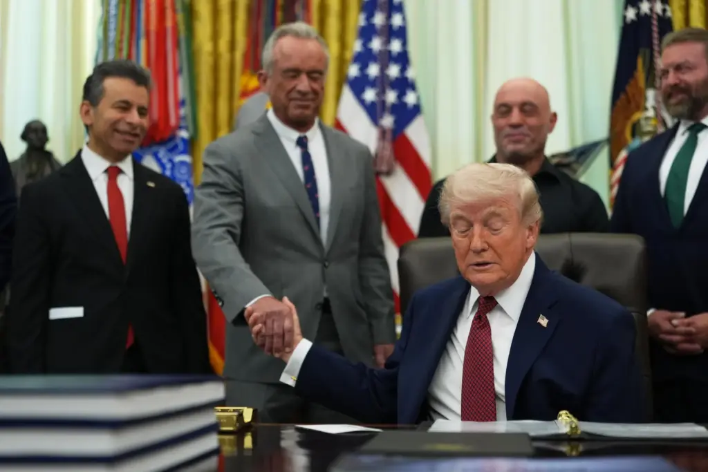 President Donald Trump shakes hands with U.S. Secretary of Health and Human Services Robert Kennedy Jr. in the Oval Office