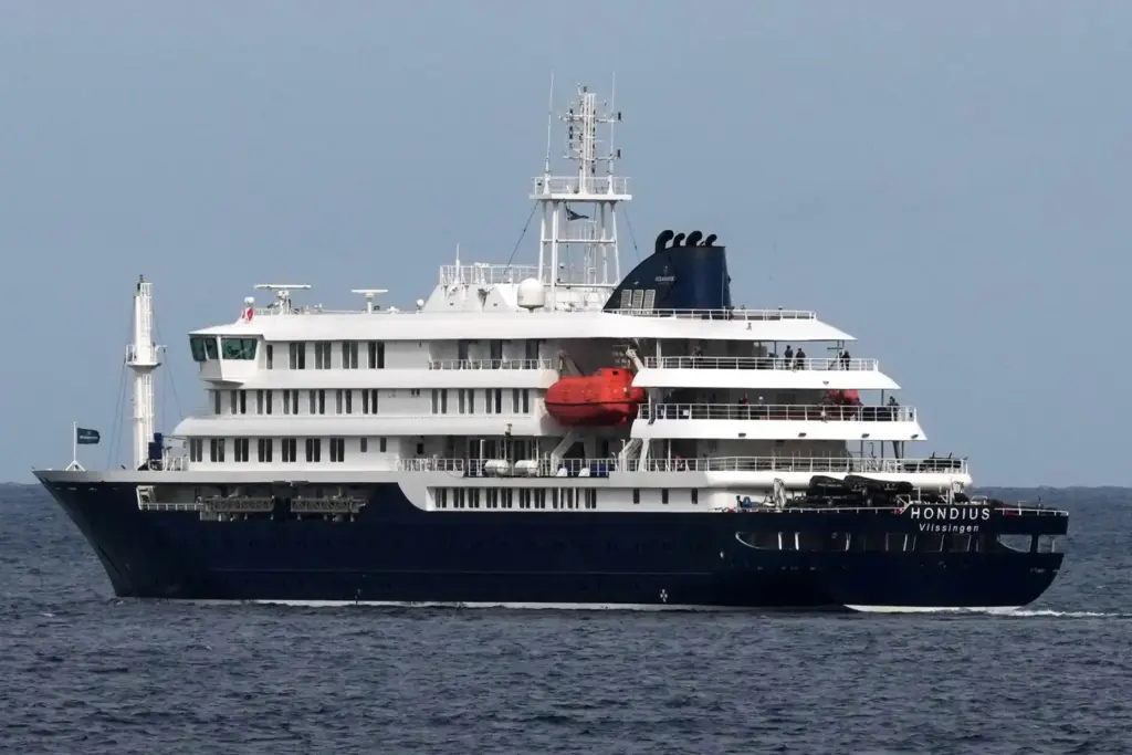 The MV Hondius cruise ship departs the port in Praia, Cape Verde.