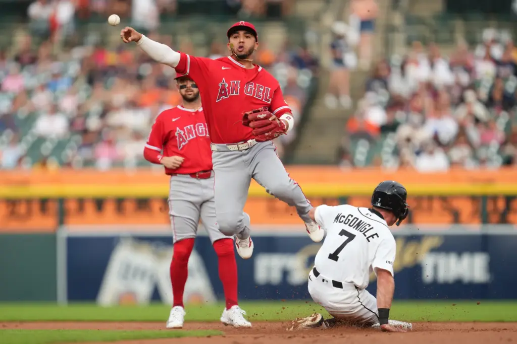 Angels second baseman Oswald Peraza throws to first base to...