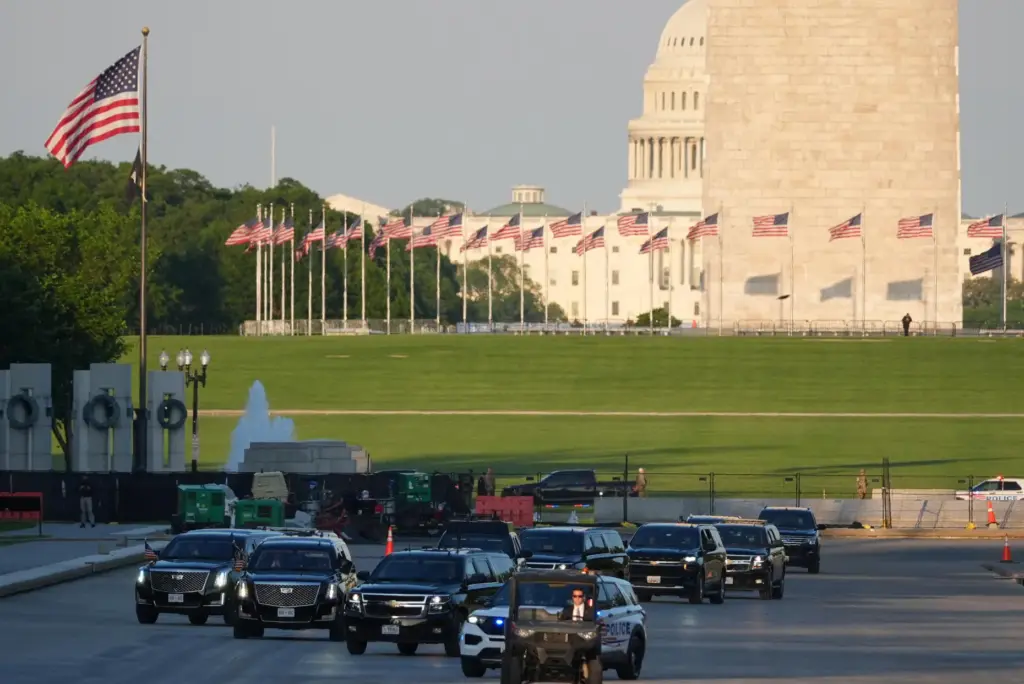The motorcade with President Donald Trump drives in the Lincoln Memorial Reflecting Pool.