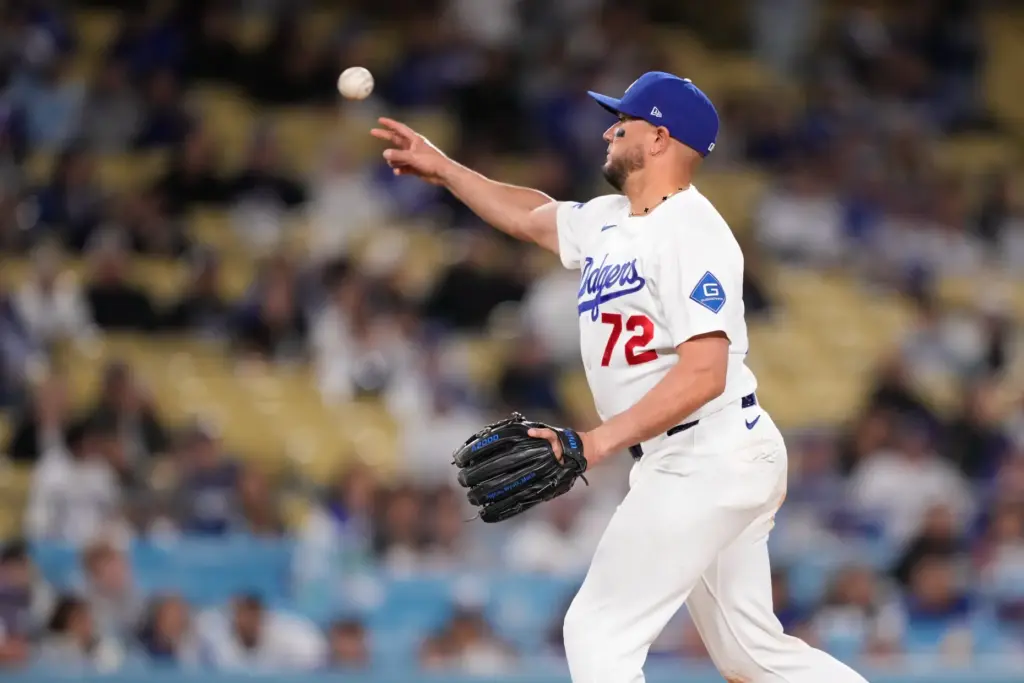 Dodgers infielder Miguel Rojas throws a pitch during the ninth...