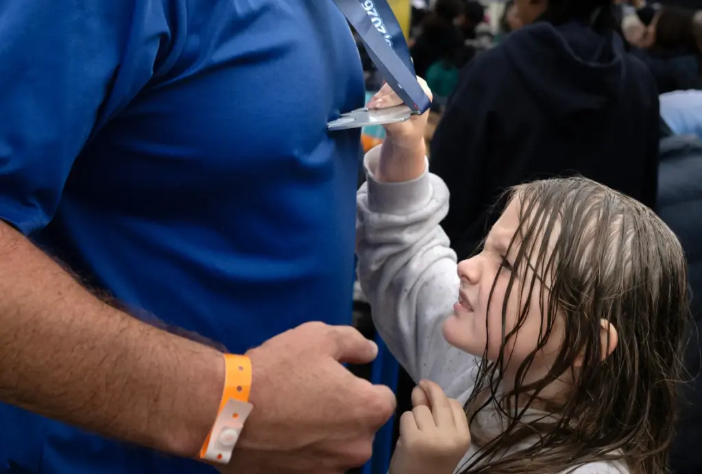 Six-year-old Hannah Haydon checks out her dad Scott Haydon’s medal...