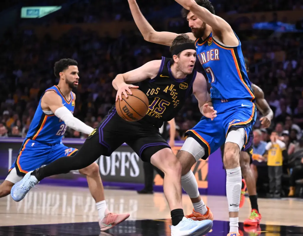 Lakers guard Austin Reaves drives to the basket as Oklahoma...
