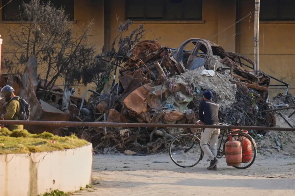 A person carries gas cylinders on his bicycle in Kathmandu
