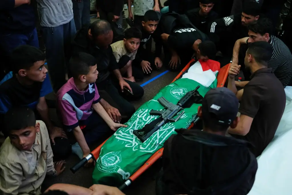 Palestinians mourn over a body