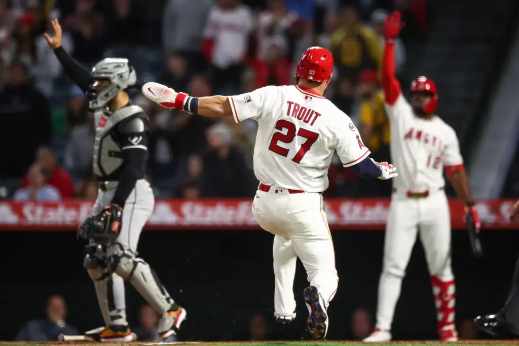 Angels star Mike Trout slides home to score during the...