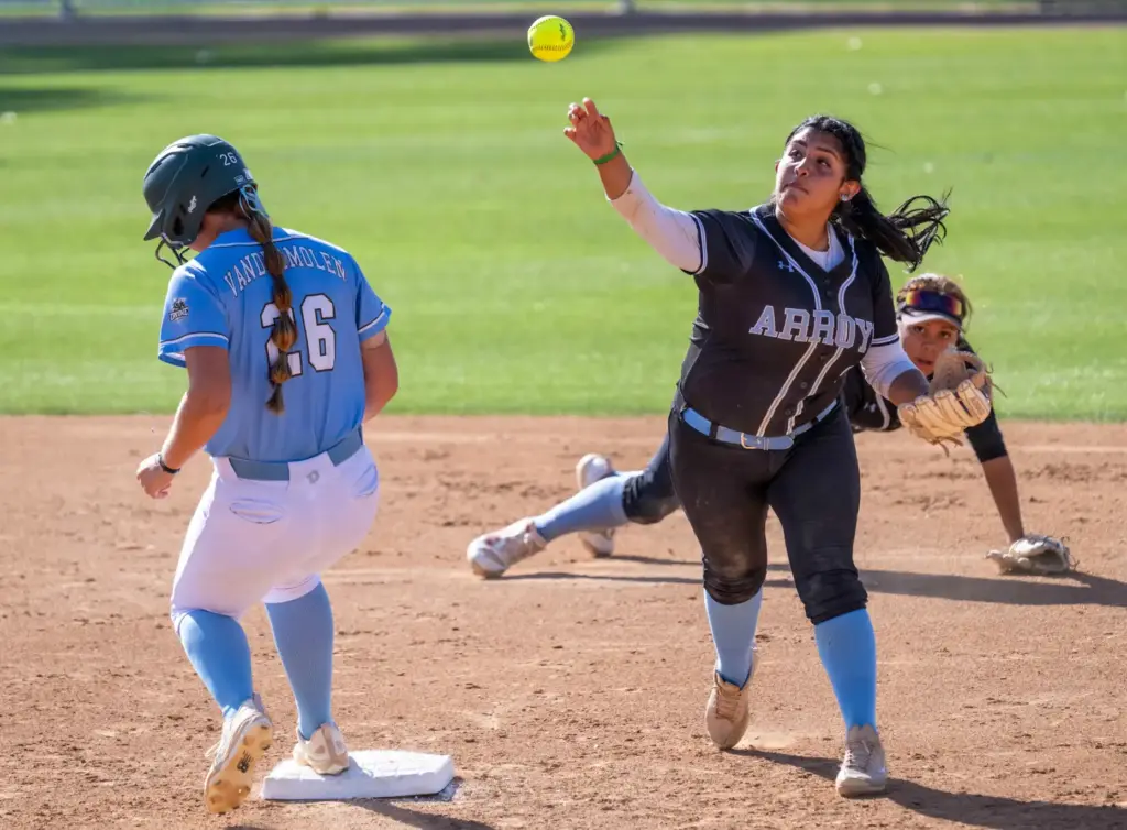 Arroyo second baseman Ruby Morales throws to first base, after...