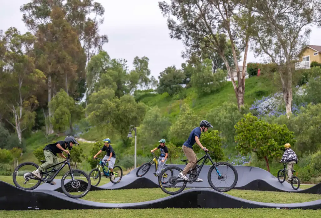 A group of friends create a train of bikes as...