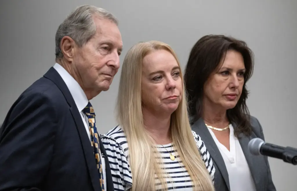Tommi Jo Mejer, center, the mother of a 14-year-old accused...
