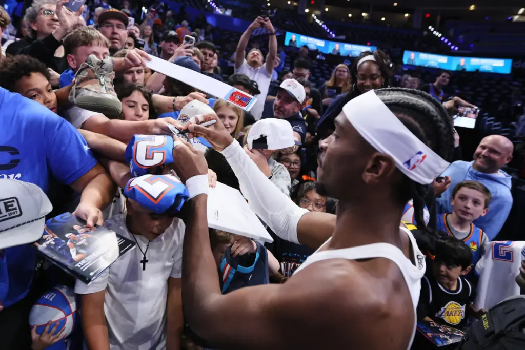 Oklahoma City Thunder star Shai Gilgeous-Alexander signs autographs for fans...
