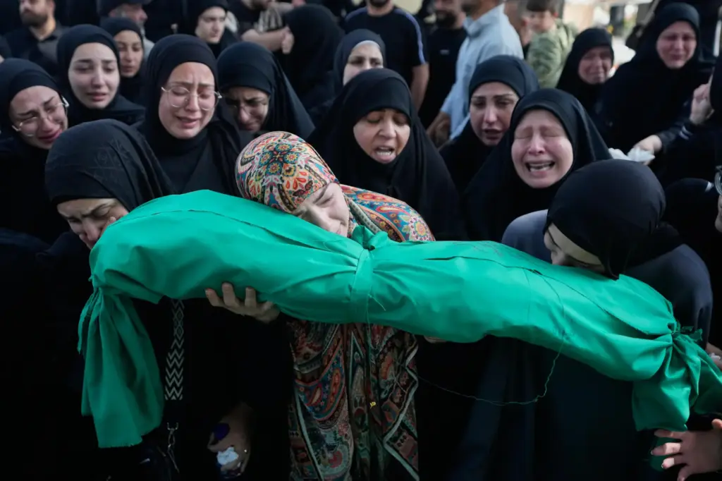 Women grieve as they carry the body of 6-month-old Mariam Fahos.