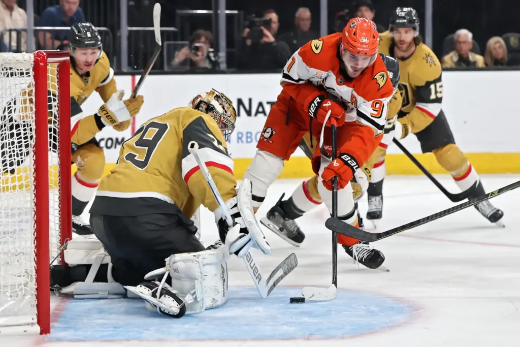 The Ducks’ Leo Carlsson, right, shoots the puck as Vegas...