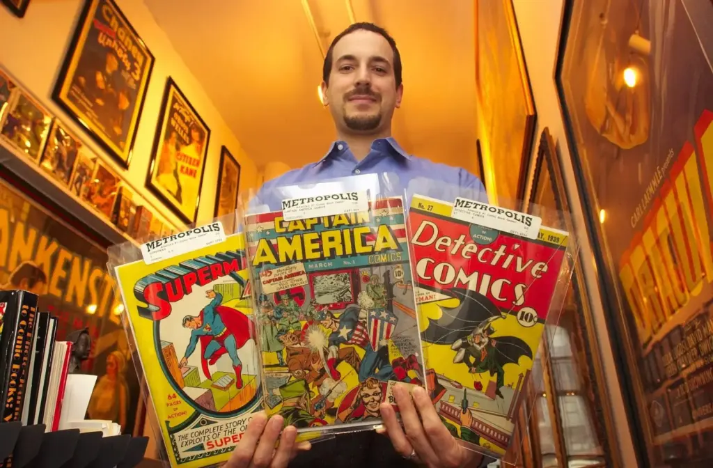 File – Vincent Zurzolo, co-partner of Metropolis Collectibles, holds three...