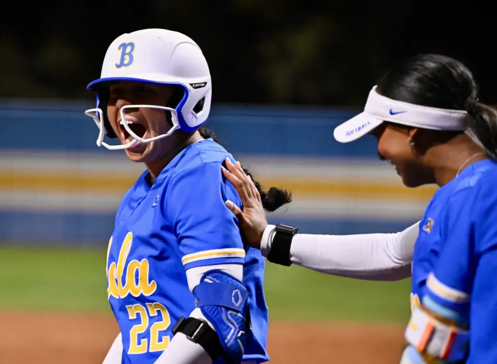 Bri Alejandre #22 of the UCLA Bruins reacts after hitting...