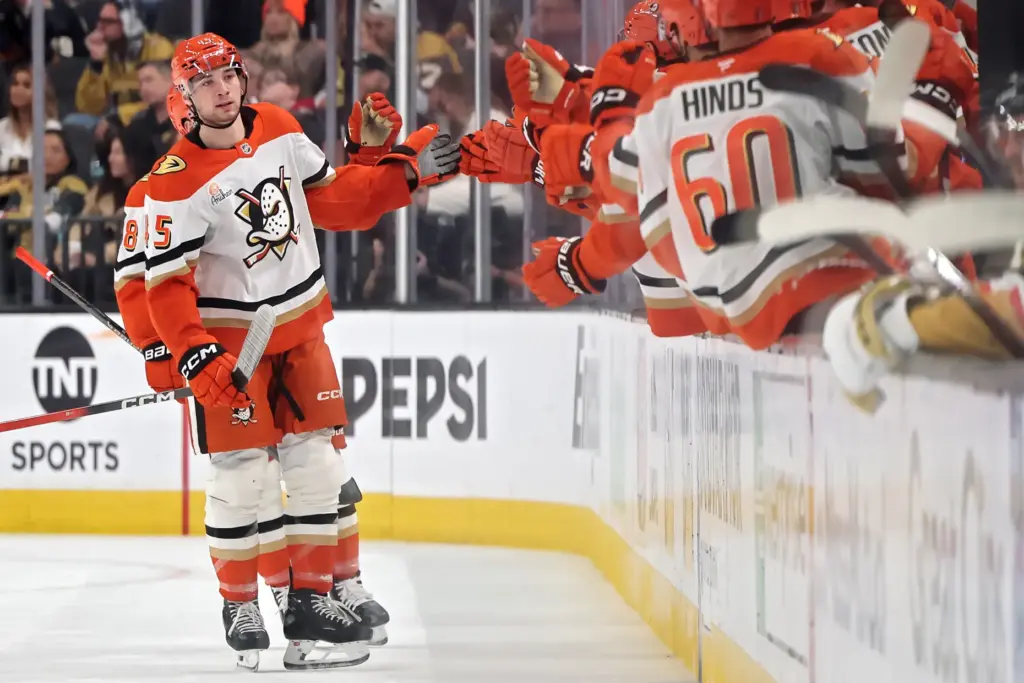 The Ducks’ Beckett Sennecke, left, celebrates with teammates at the...