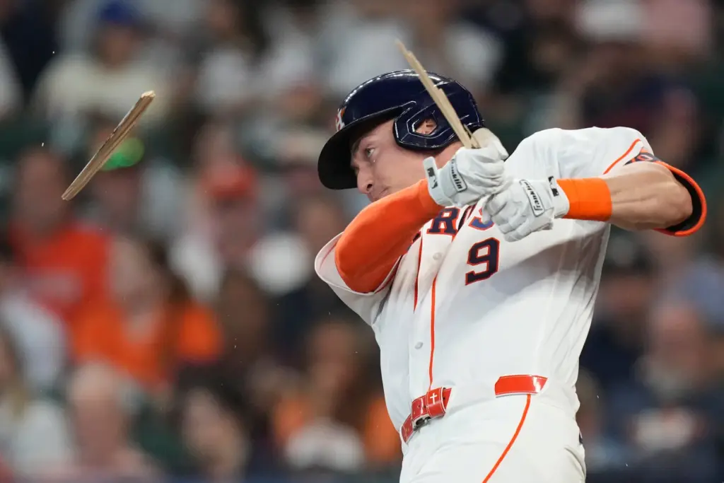 The Houston Astros’ Zach Dezenzo breaks a bat during the...