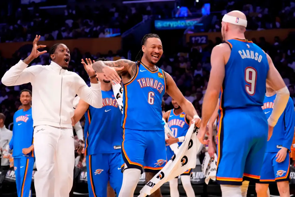 Oklahoma City Thunder guard Alex Caruso, right, celebrates his dunk...