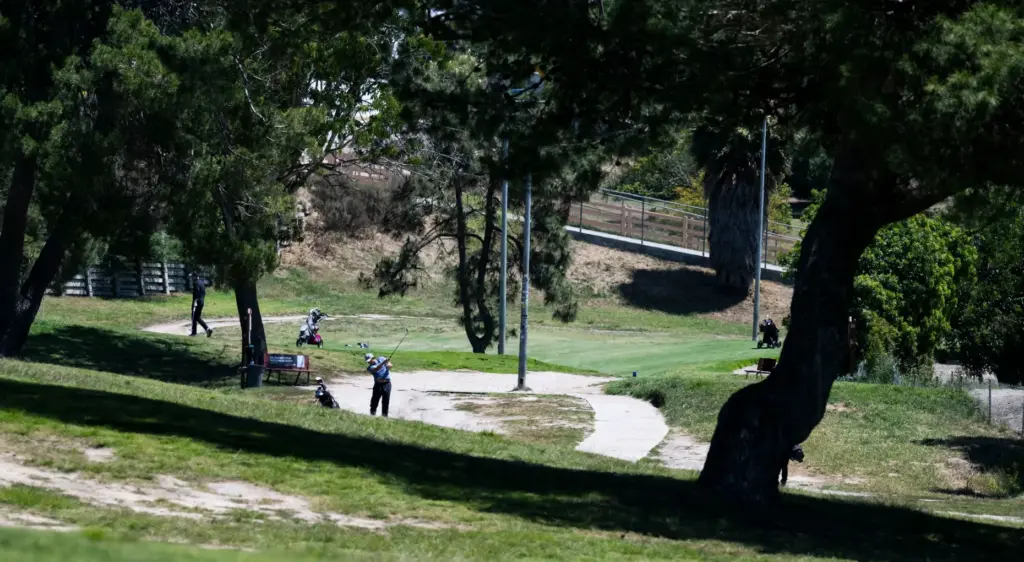 A golfer tees off at Newport Beach Golf Course in...