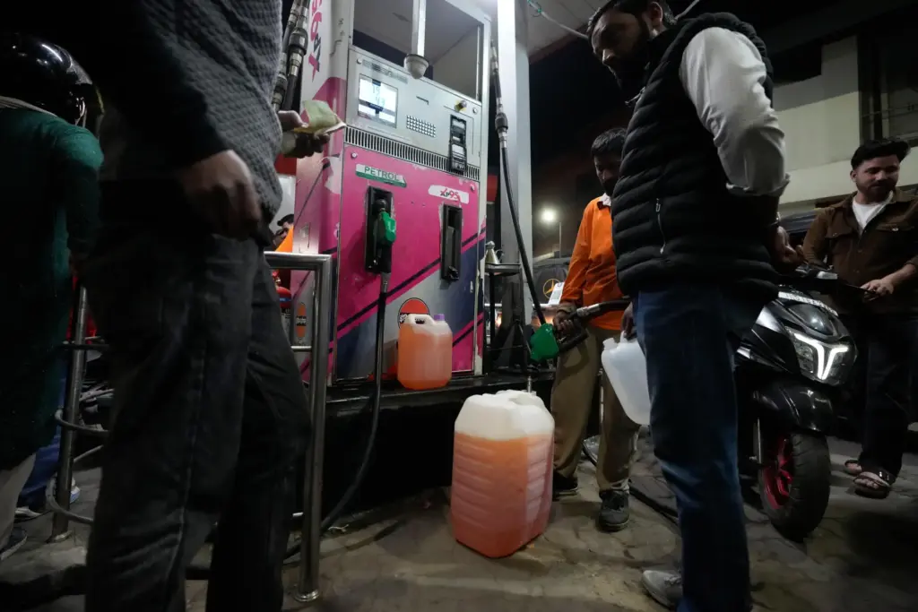 People store fuel in a plastic can at a petrol pump in Srinagar, Indian-controlled Kashmir.