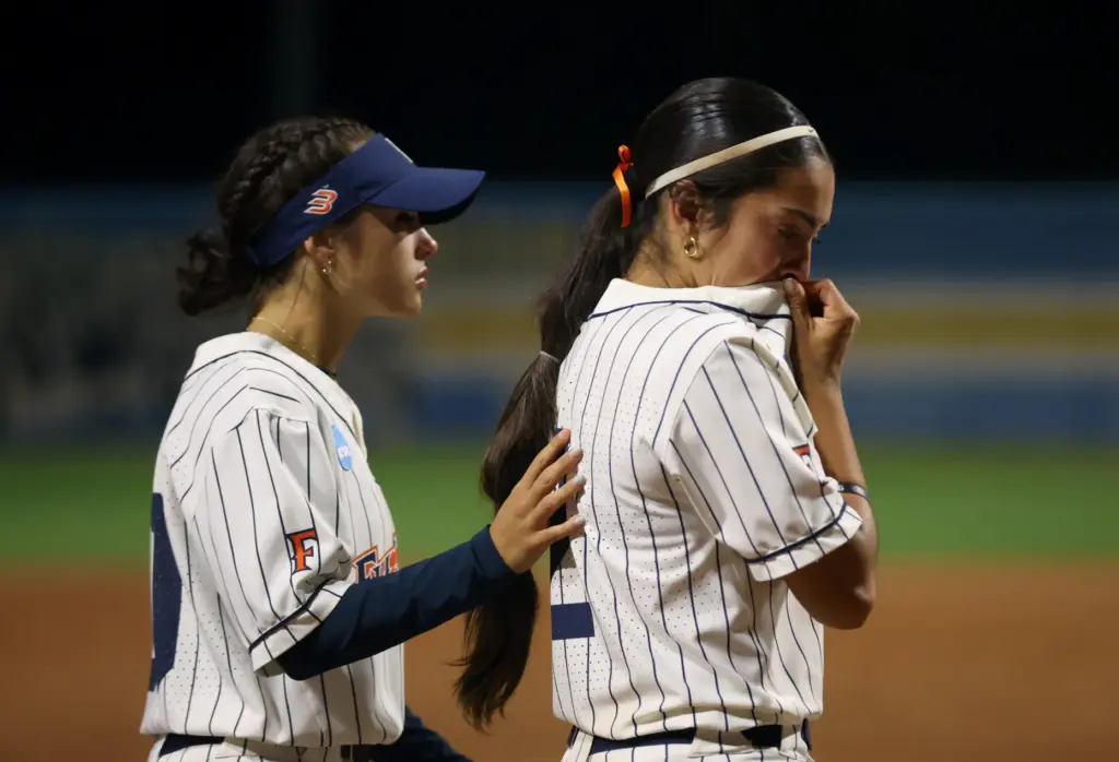 Cal State Fullertonâs Sophia Newcomb, left places a hand on...