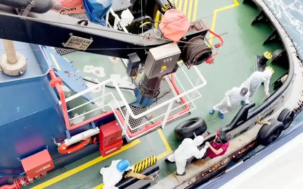Health workers get off the Dutch-flagged MV Hondius.