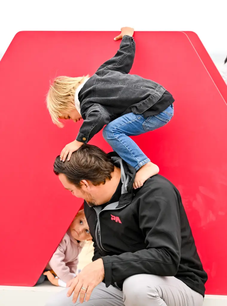 Pacific Airshow CEO Kevin Elliott plays with his kids, Jett...