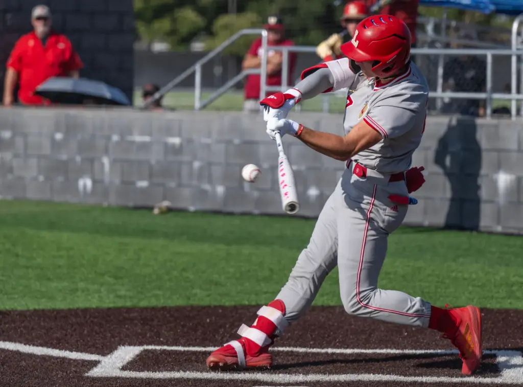 Orange Lutheran infielder C.J. Weinstein hits the ball during a...