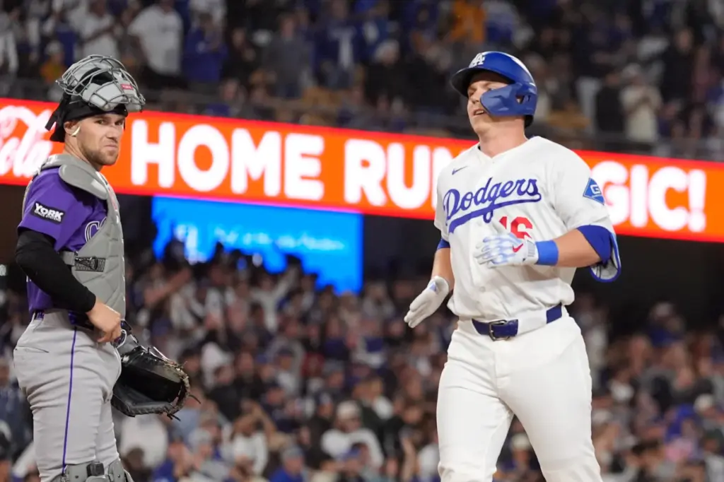 The Dodgers’ Will Smith, right, crosses home plate after hitting...