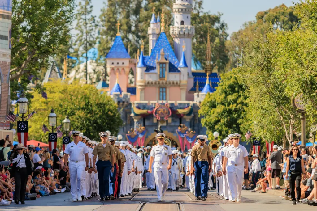 U.S. Sailors, Marines and Coast Guardsmen march down Main Street...