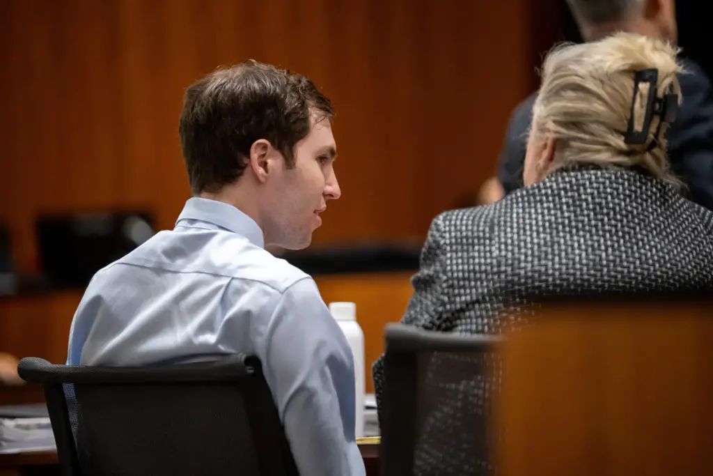 Tyler Robinson speaks with his attorney Kathryn Nester.