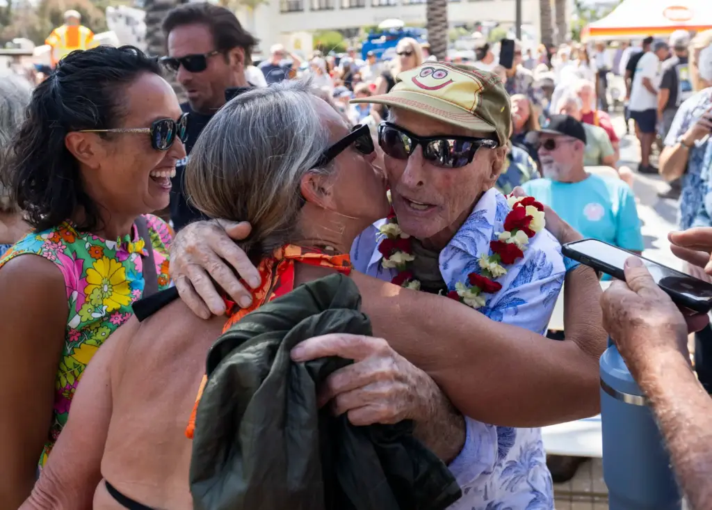 Surfer Mickey MuÃ±oz gets a kiss as he arrives for...