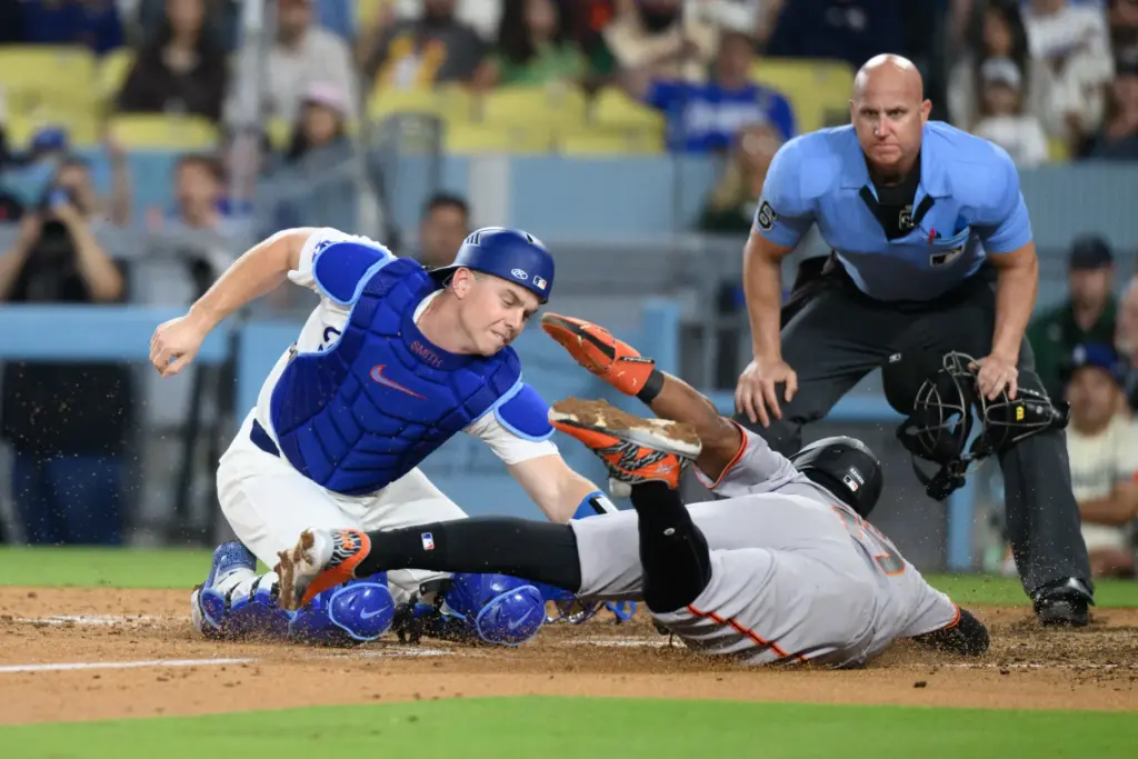 Dodgers catcher Will Smith, left, tags the San Francisco Giants’...