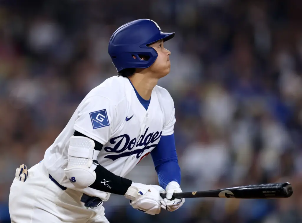 Dodgers star Shohei Ohtani watches the flight of his fly...
