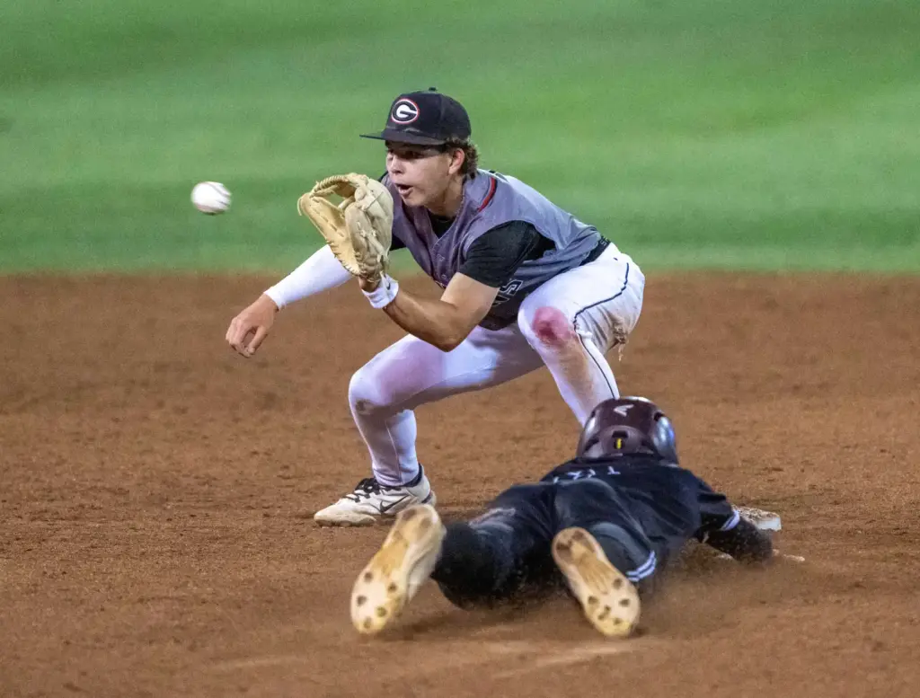 Glendora shortstop Cody Baeza tags Laguna Beach outfielder Otis Boultinghouse...