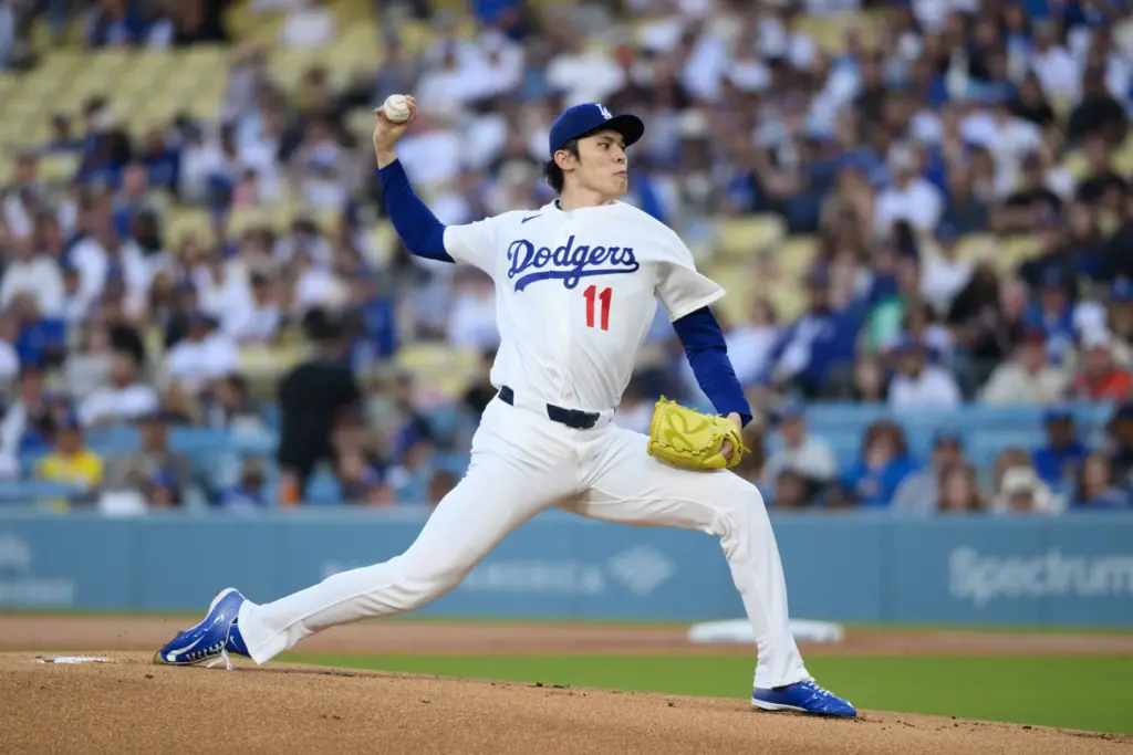 Dodgers starting pitcher Roki Sasaki throws to the plate during...