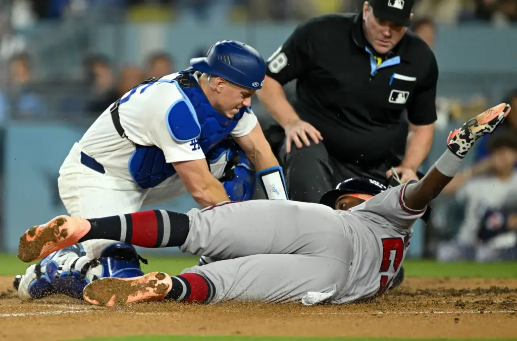 Dodgers catcher Will Smith, left, tags out the Atlanta Braves’...
