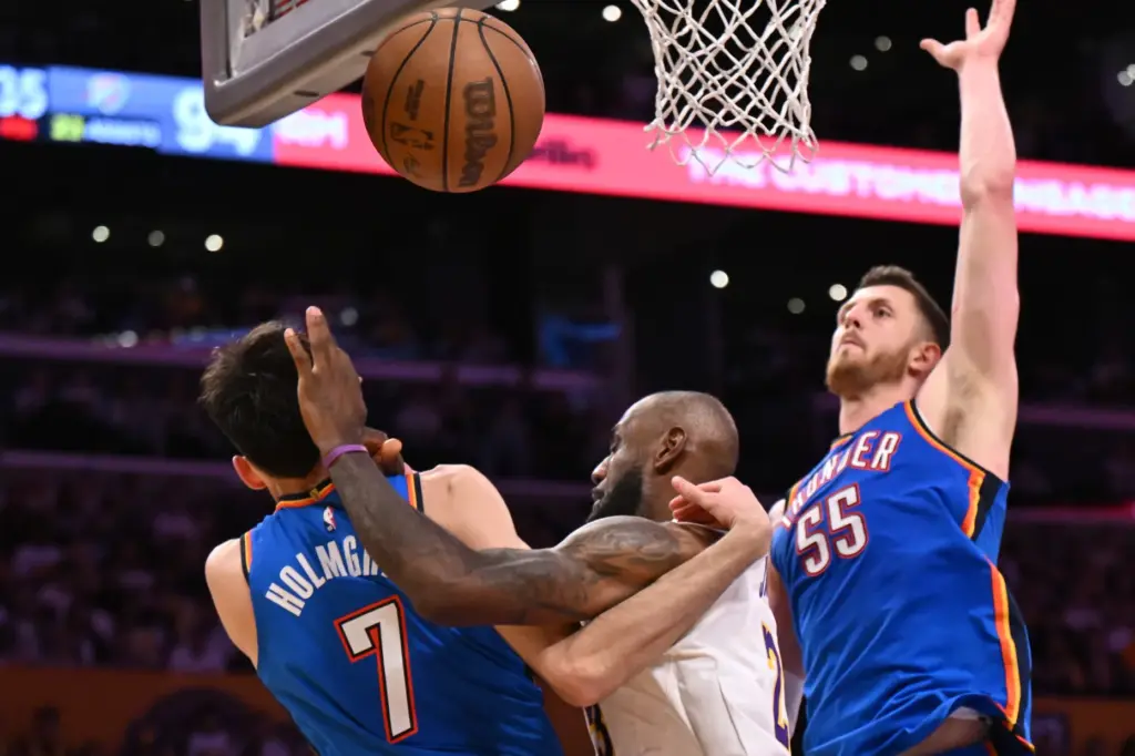 Lakers star LeBron James, middle, gets fouled by Oklahoma City...