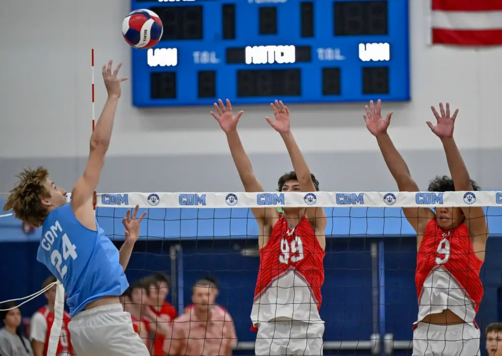 Corona del Mar outside hitter Ben Brown hits the ball...