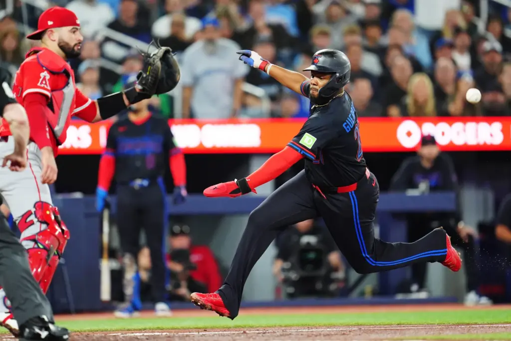 Toronto Blue Jays star Vladimir Guerrero Jr., right, runs home...