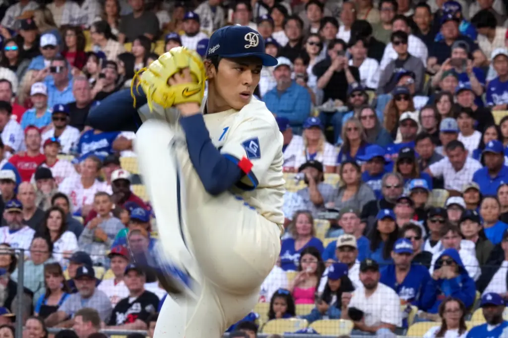 Dodgers starting pitcher Roki Sasaki throws to the plate during...