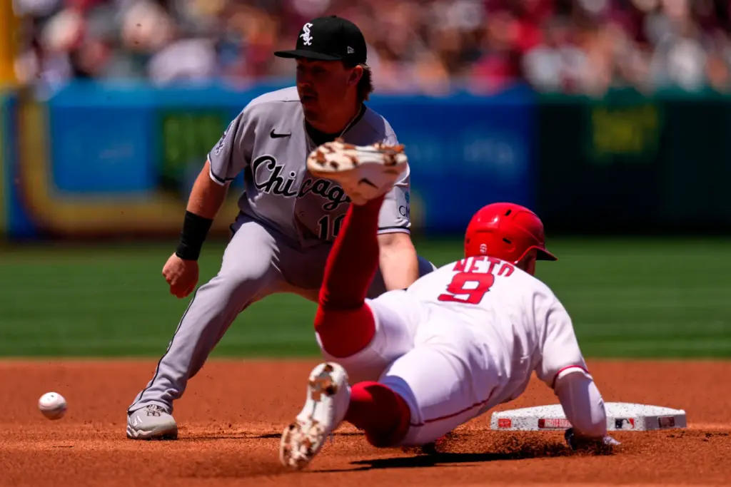 The Angels’ Zach Neto, right, tries to steal second base...